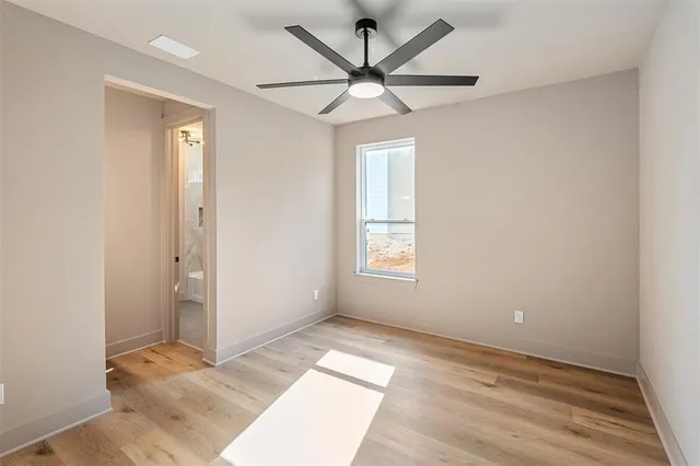 a view of a big room with wooden floor and windows in a room