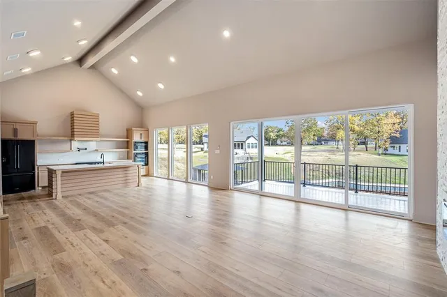 a view of a kitchen with kitchen island and stainless steel appliances