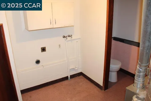 a bathroom with a granite countertop sink and a toilet