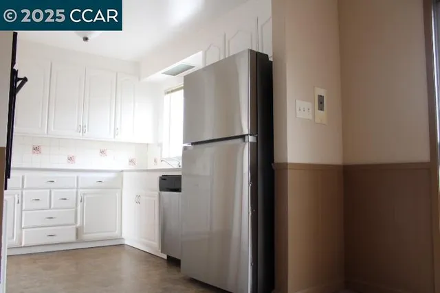a white refrigerator freezer sitting in a kitchen