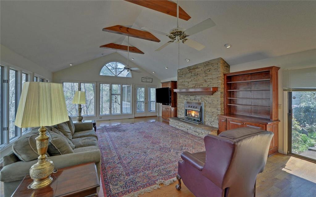 290 Waterfall Drive Cleveland, GA 30528 - Photo 13 of 46 a living room with furniture a large window and a fireplace