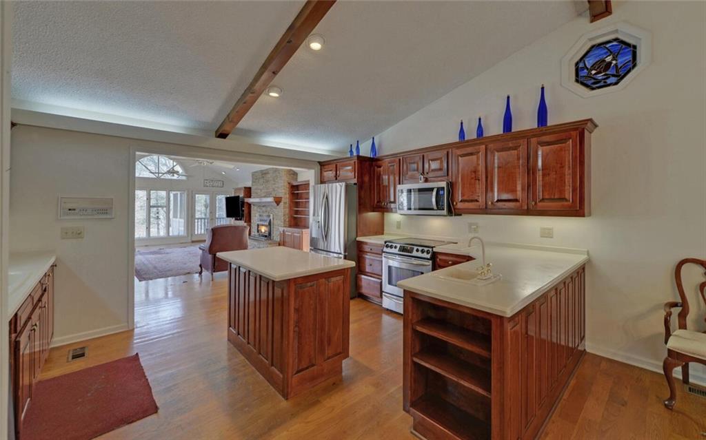 290 Waterfall Drive Cleveland, GA 30528 - Photo 18 of 46 a kitchen that has a lot of cabinets in it and wooden floors