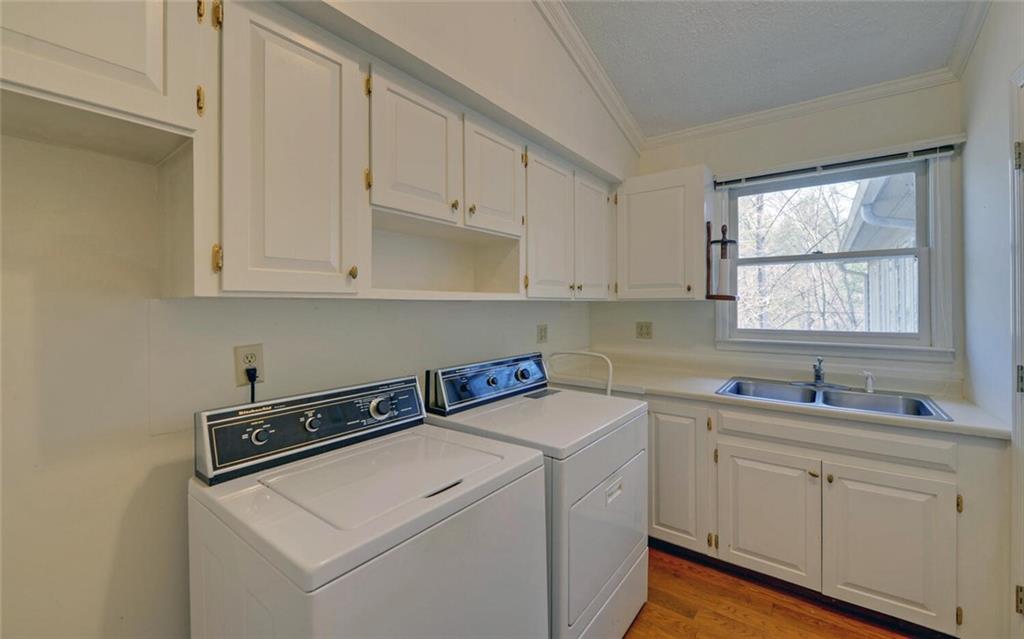 290 Waterfall Drive Cleveland, GA 30528 - Photo 21 of 46 a utility room with stainless steel appliances white cabinets sink and window