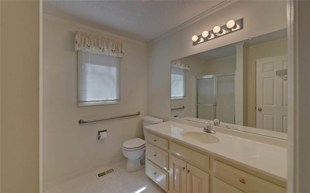 290 Waterfall Drive Cleveland, GA 30528 - Photo 23 of 46 a bathroom with a toilet sink and mirror