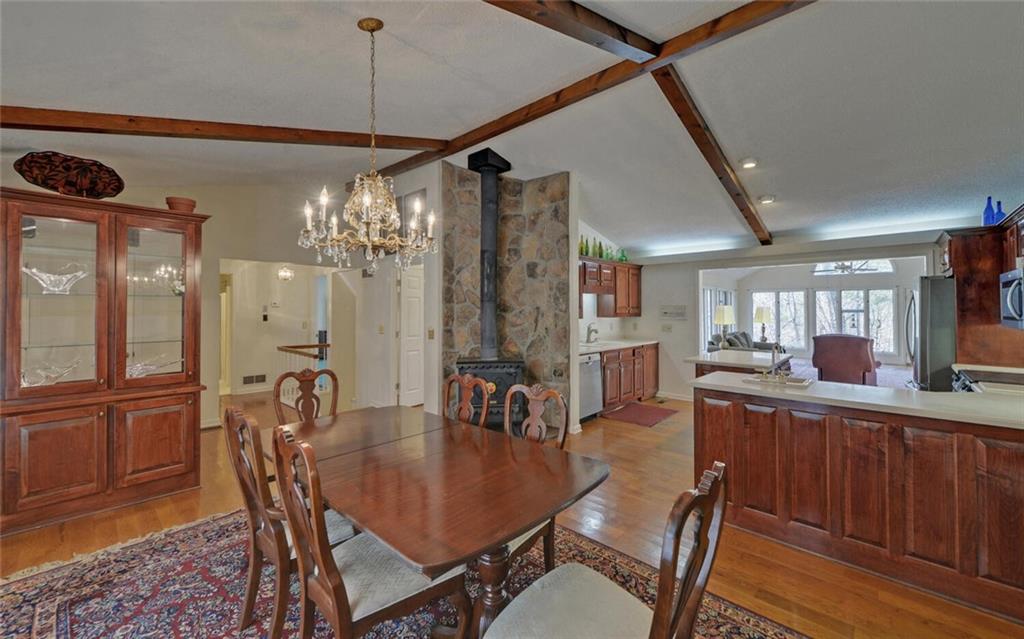 290 Waterfall Drive Cleveland, GA 30528 - Photo 7 of 46 a dining room with furniture a chandelier and wooden floor