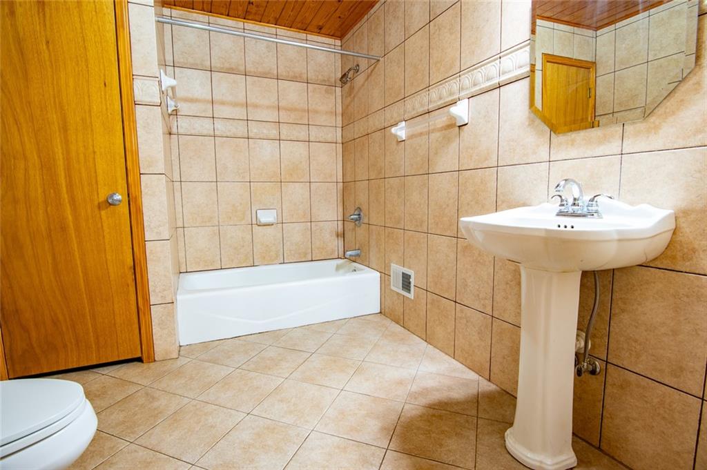 360 Parr Farm Road Covington, GA 30016 - Photo 36 of 74 a bathroom with a sink and bathtub
