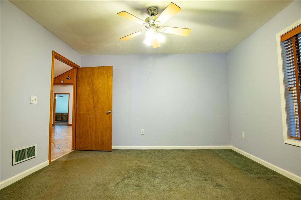 360 Parr Farm Road Covington, GA 30016 - Photo 40 of 74 an empty room with closet and a chandelier fan