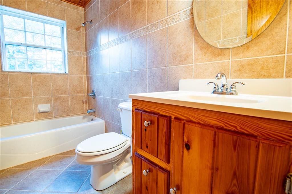 360 Parr Farm Road Covington, GA 30016 - Photo 43 of 74 a bathroom with a sink a toilet and bathtub