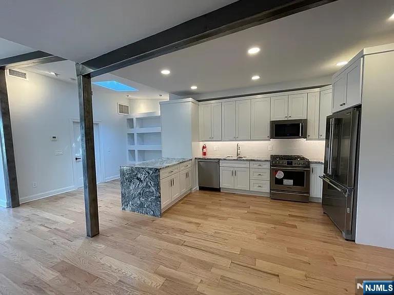 9009 Riverside Place, Unit 2 North Bergen, NJ 07047 - Photo 2 of 14 a large kitchen with stainless steel appliances granite countertop a large counter top stainless steel appliances and cabinets
