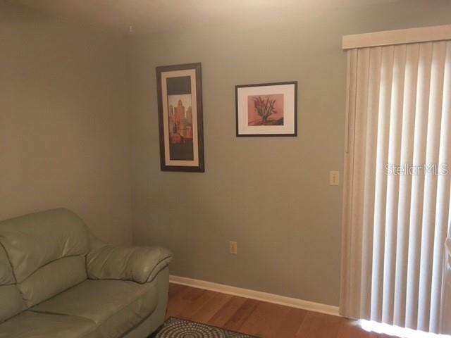 4007 Southwest 20th Lane, Unit 33B Gainesville, FL 32607 - Photo 8 of 11 a living room with furniture and a window