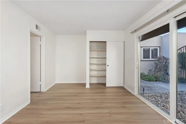 a view of room with wooden floor and entryway