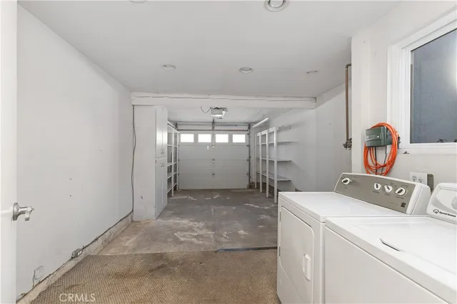 a view of storage and utility room with washer and dryer