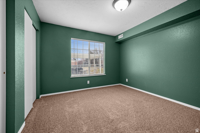 2095 South Main Street, Unit 13 Bountiful, UT 84010 - Photo 17 of 45 Carpeted empty room featuring a textured wall