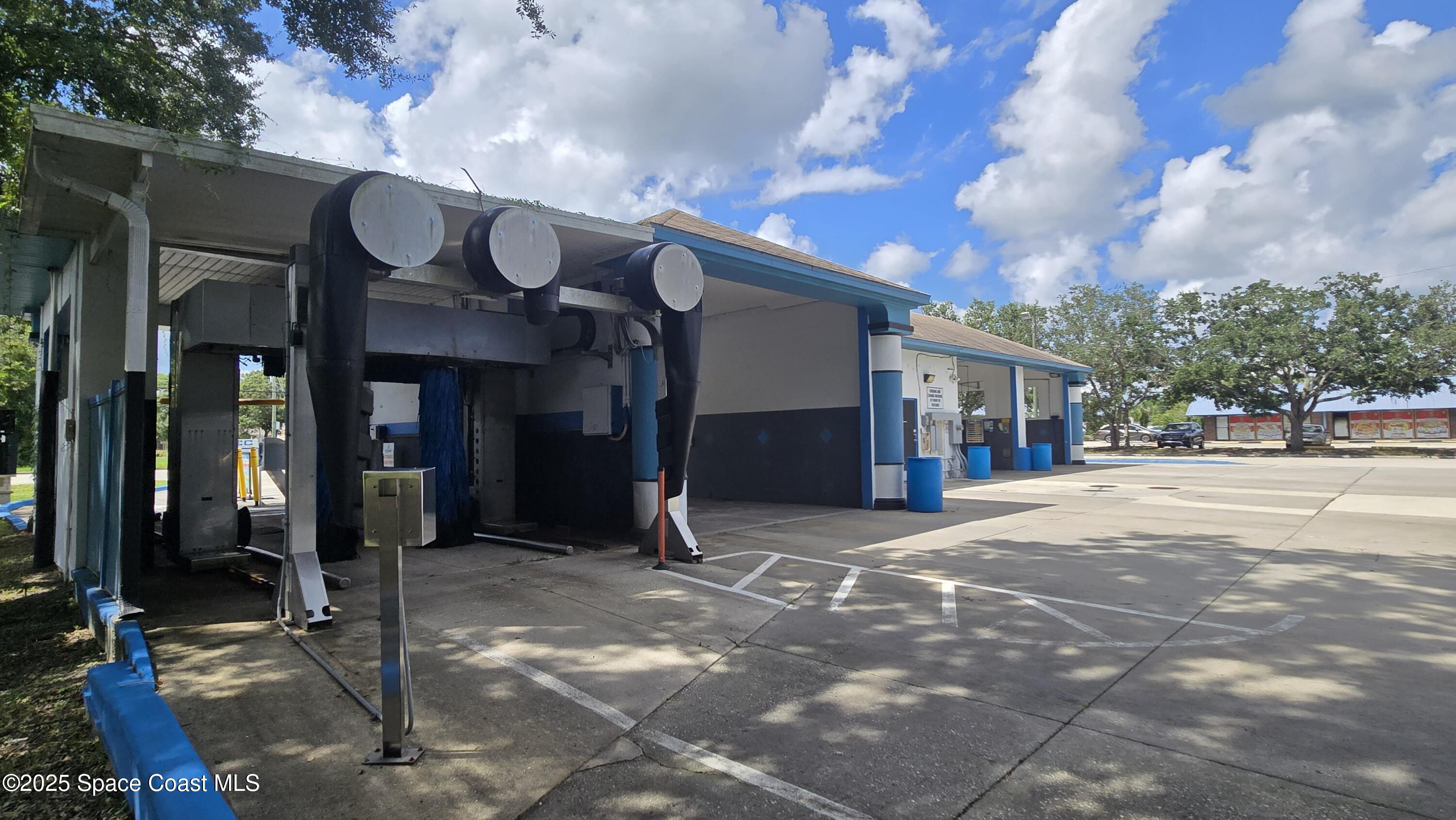 745 South Wickham Road West Melbourne, FL 32904 - Photo 12 of 67 a front view of a building with retail shops
