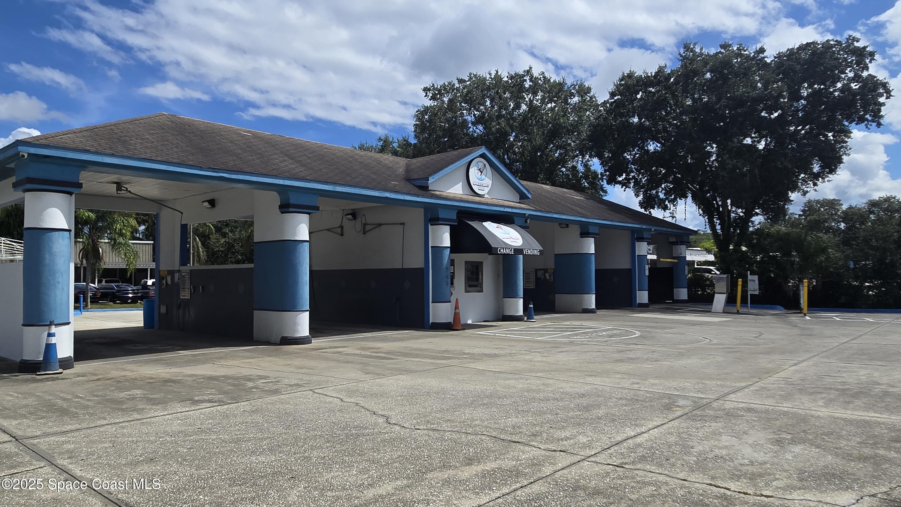 745 South Wickham Road West Melbourne, FL 32904 - Photo 4 of 67 a front view of a building with a garden