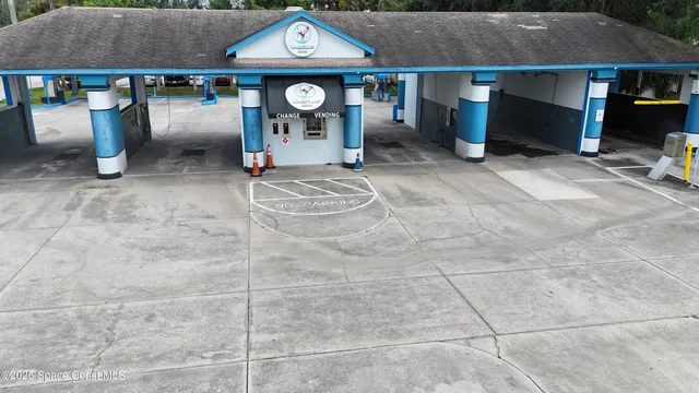 a sign board with a play ground in the back