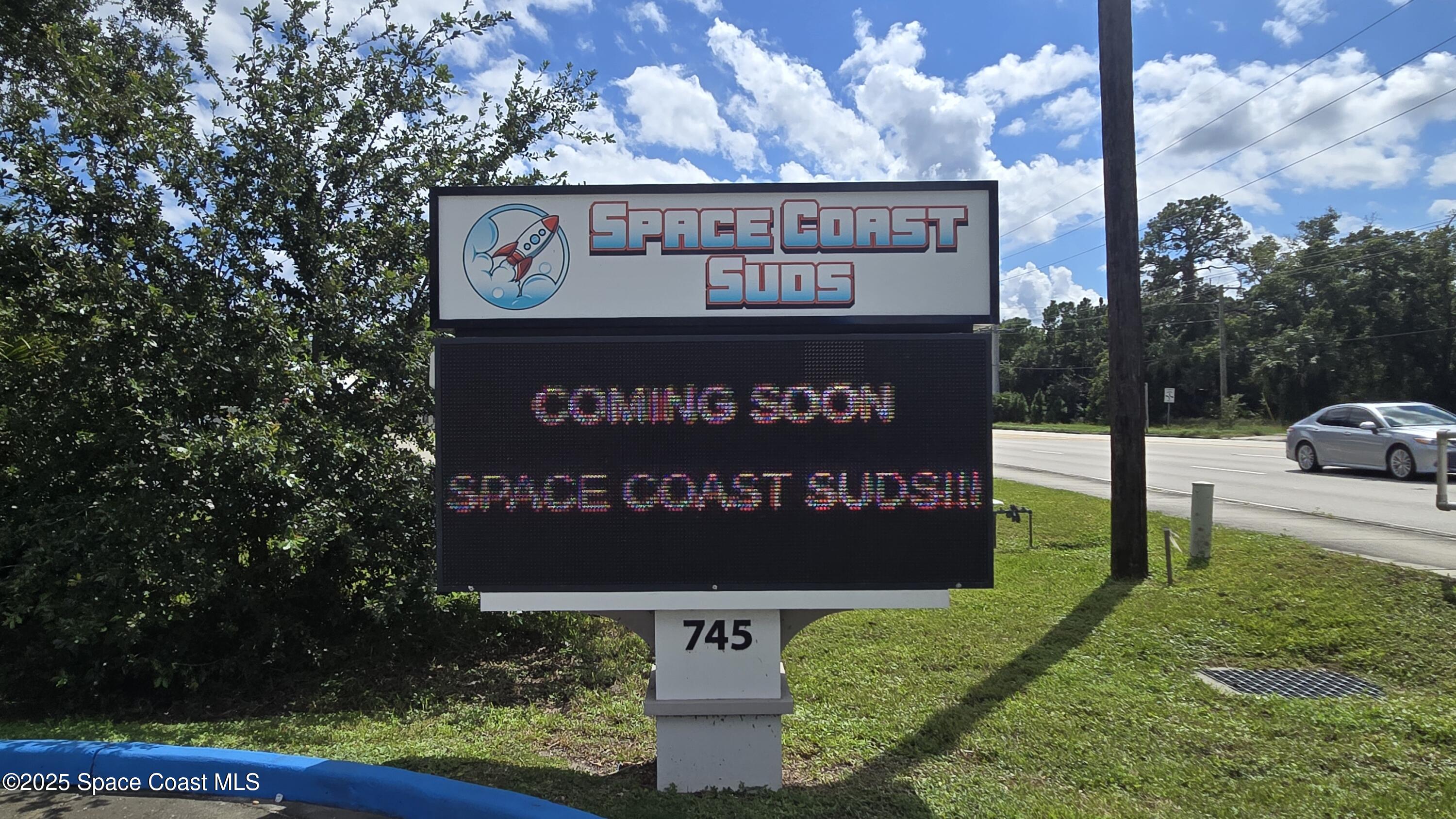 745 South Wickham Road West Melbourne, FL 32904 - Photo 7 of 67 a sign on the side of the building