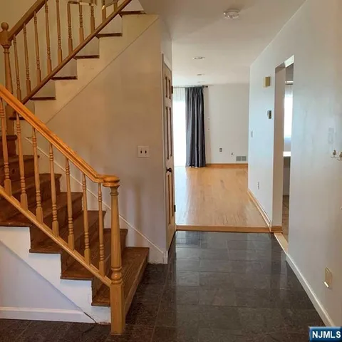 a view of staircase with wooden floor and a window