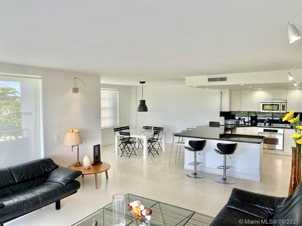 155 Ocean Ln Drive, Unit 414 Key Biscayne, FL 33149 - Photo 5 of 9 a living room with furniture and a table