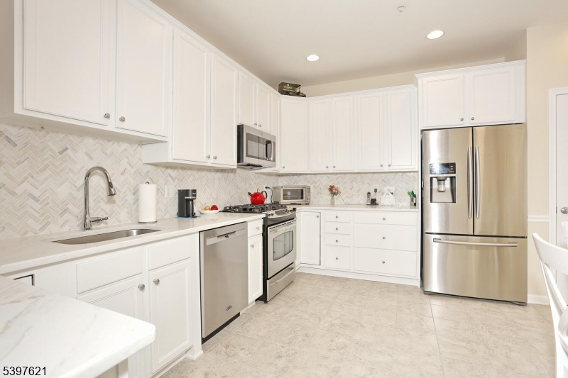 3214 Warren's Way Wanaque, NJ 07465 - Photo 15 of 42 a kitchen with white cabinets and stainless steel appliances