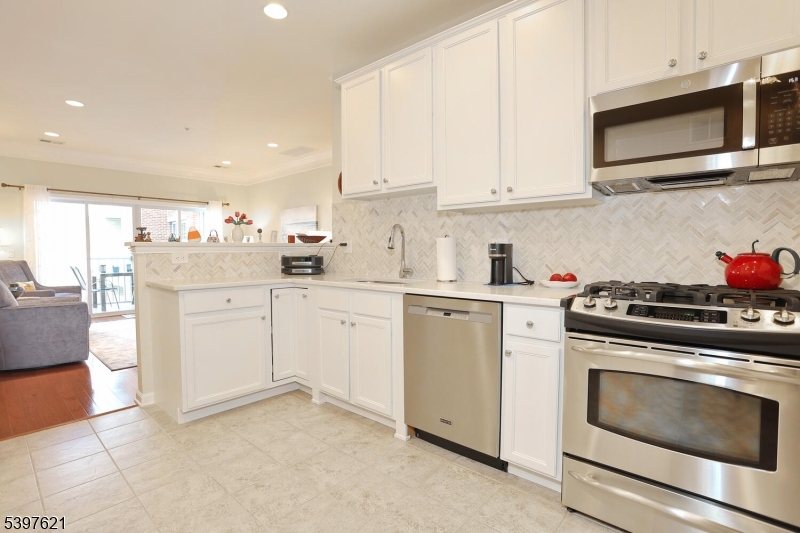 3214 Warren's Way Wanaque, NJ 07465 - Photo 18 of 42 a kitchen with white cabinets stainless steel appliances and sink