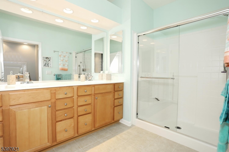 3214 Warren's Way Wanaque, NJ 07465 - Photo 22 of 42 a bathroom with a shower sink and mirror