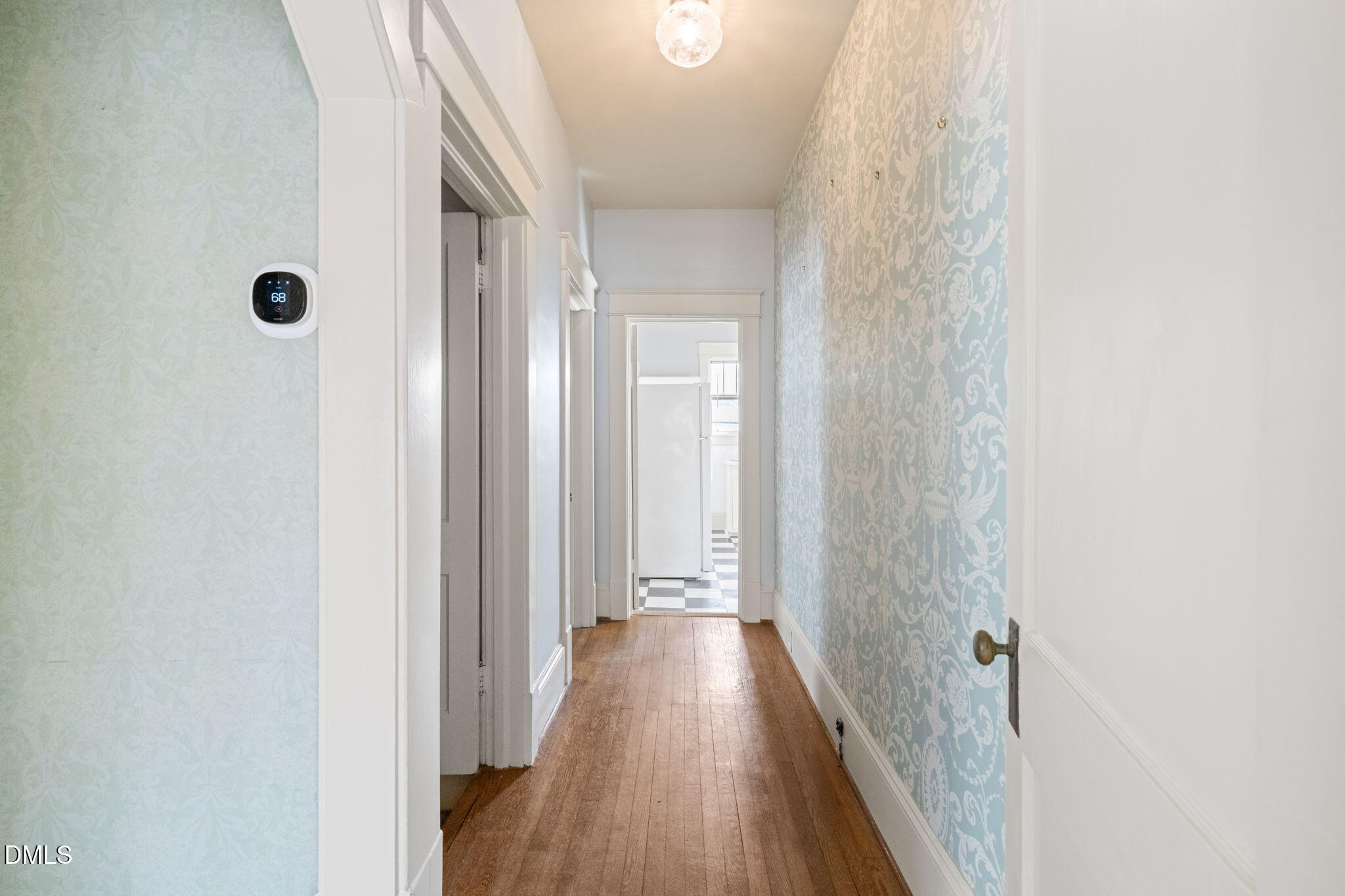 4 Dixie Trail Raleigh, NC 27607 - Photo 16 of 23 a view of a hallway with wooden floor and a bathroom