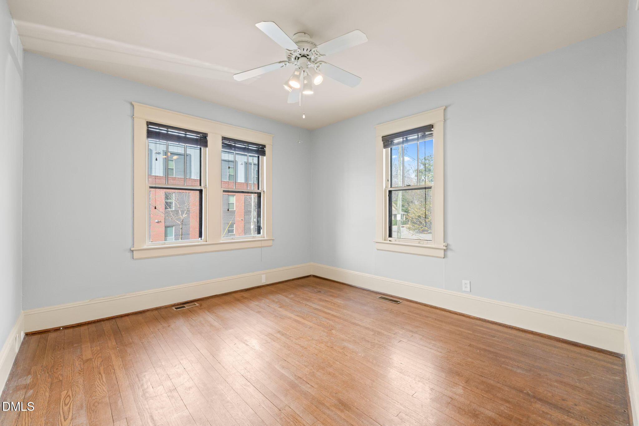 4 Dixie Trail Raleigh, NC 27607 - Photo 17 of 23 a view of an empty room with window and wooden floor