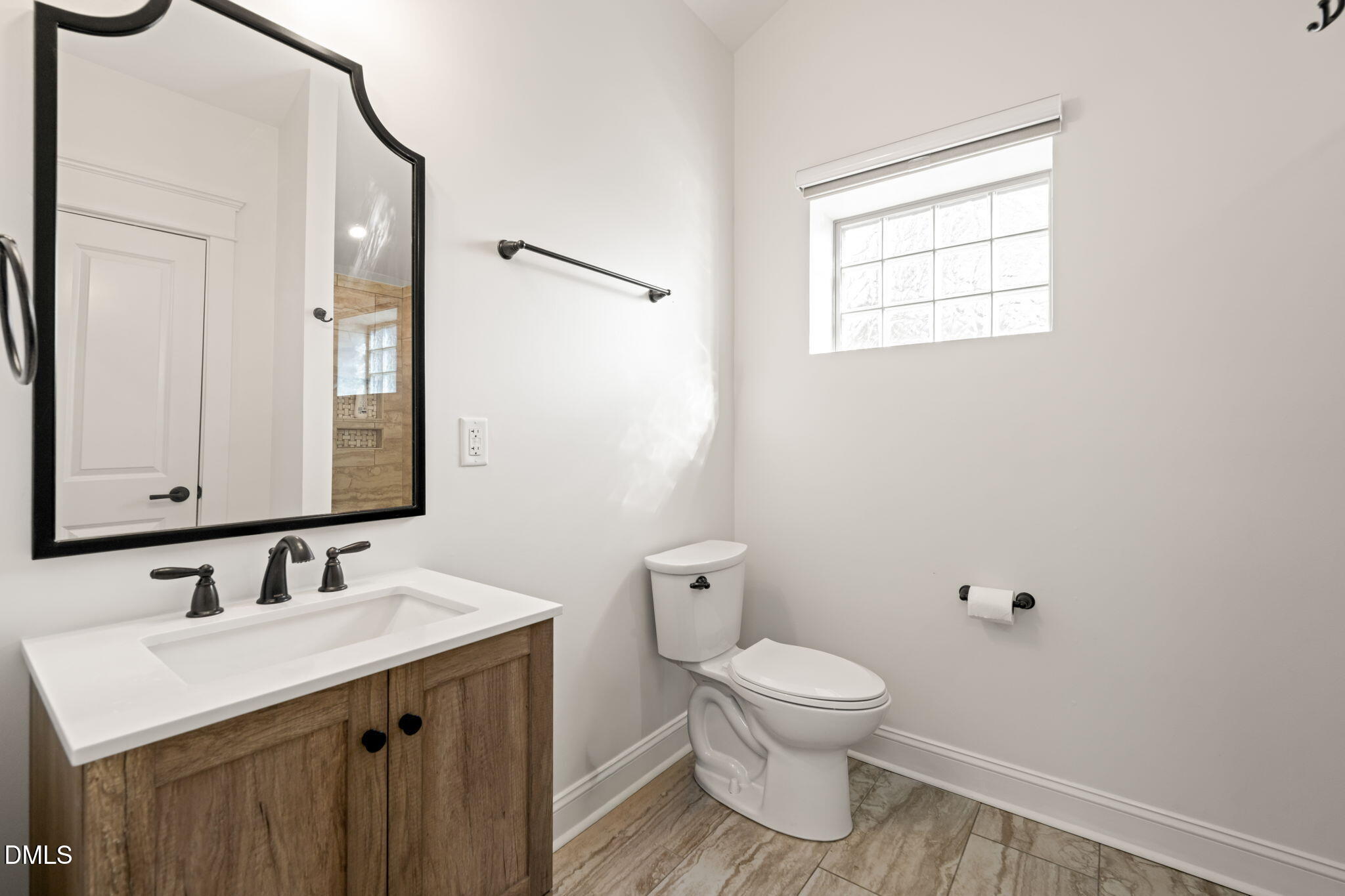 4 Dixie Trail Raleigh, NC 27607 - Photo 7 of 23 a bathroom with a toilet sink and mirror