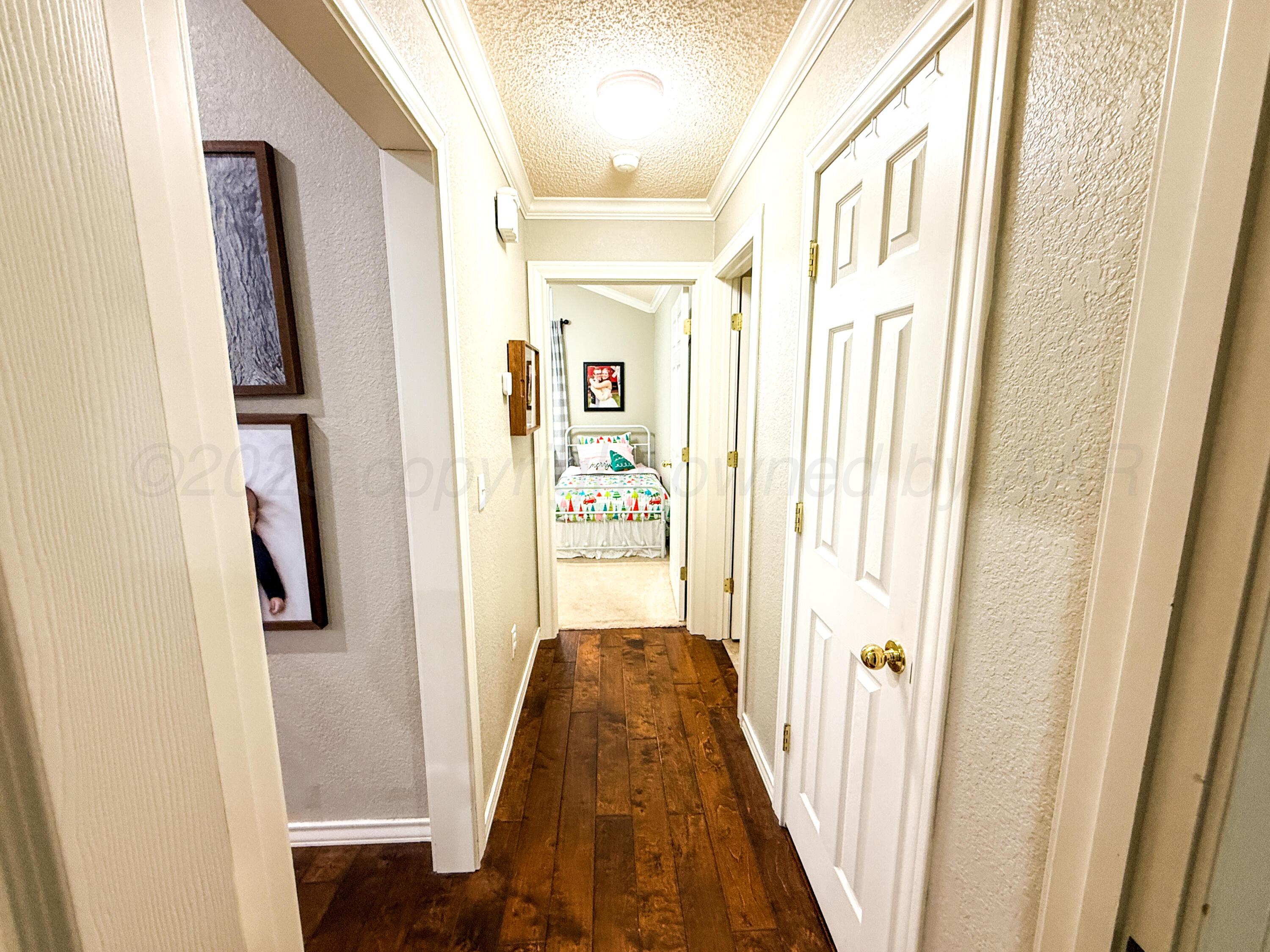 5724 Spencer Street Amarillo, TX 79109 - Photo 13 of 37 a view of a hallway with wooden floor and staircase