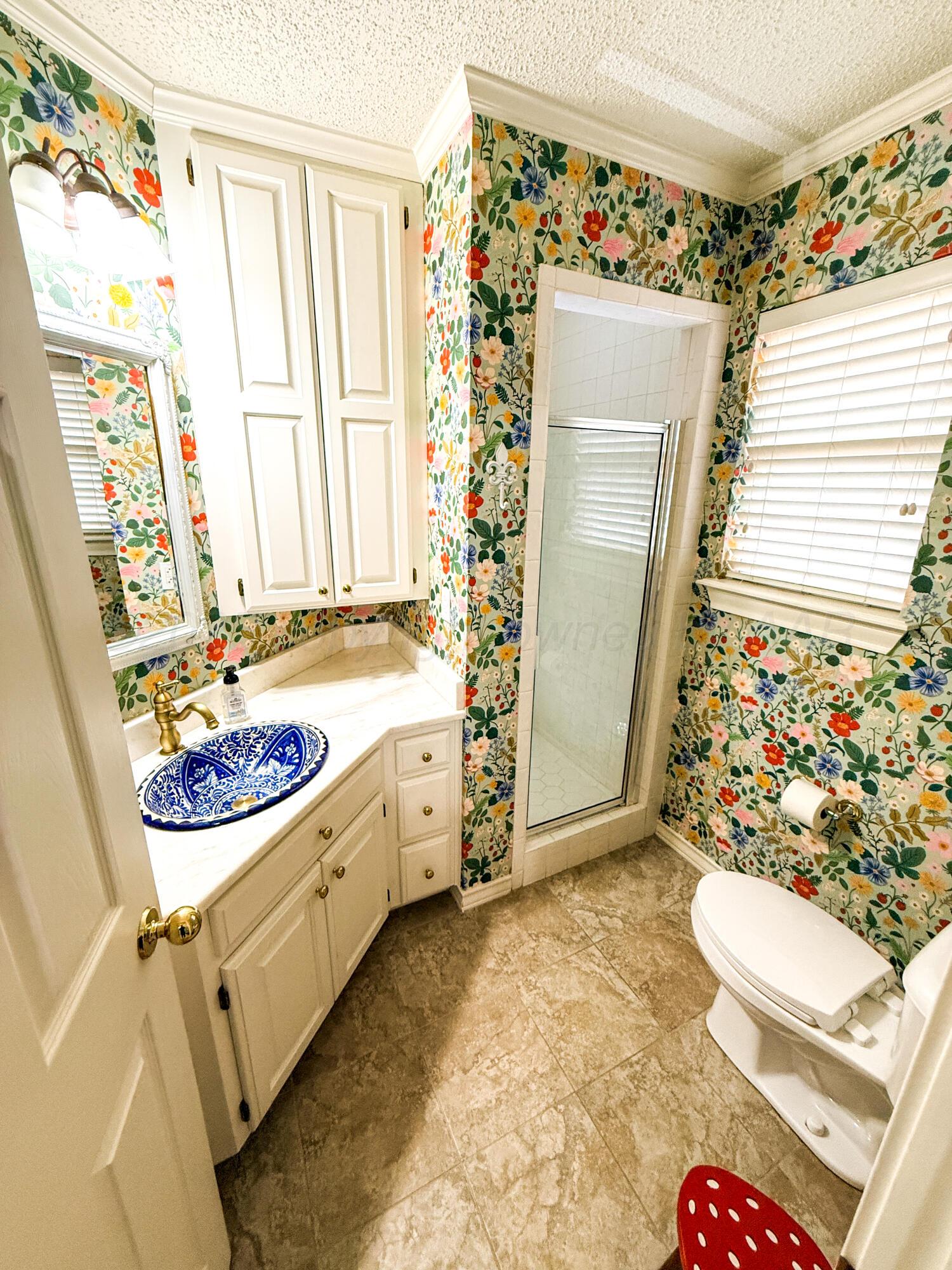5724 Spencer Street Amarillo, TX 79109 - Photo 16 of 37 a bathroom with sink toilet and shower