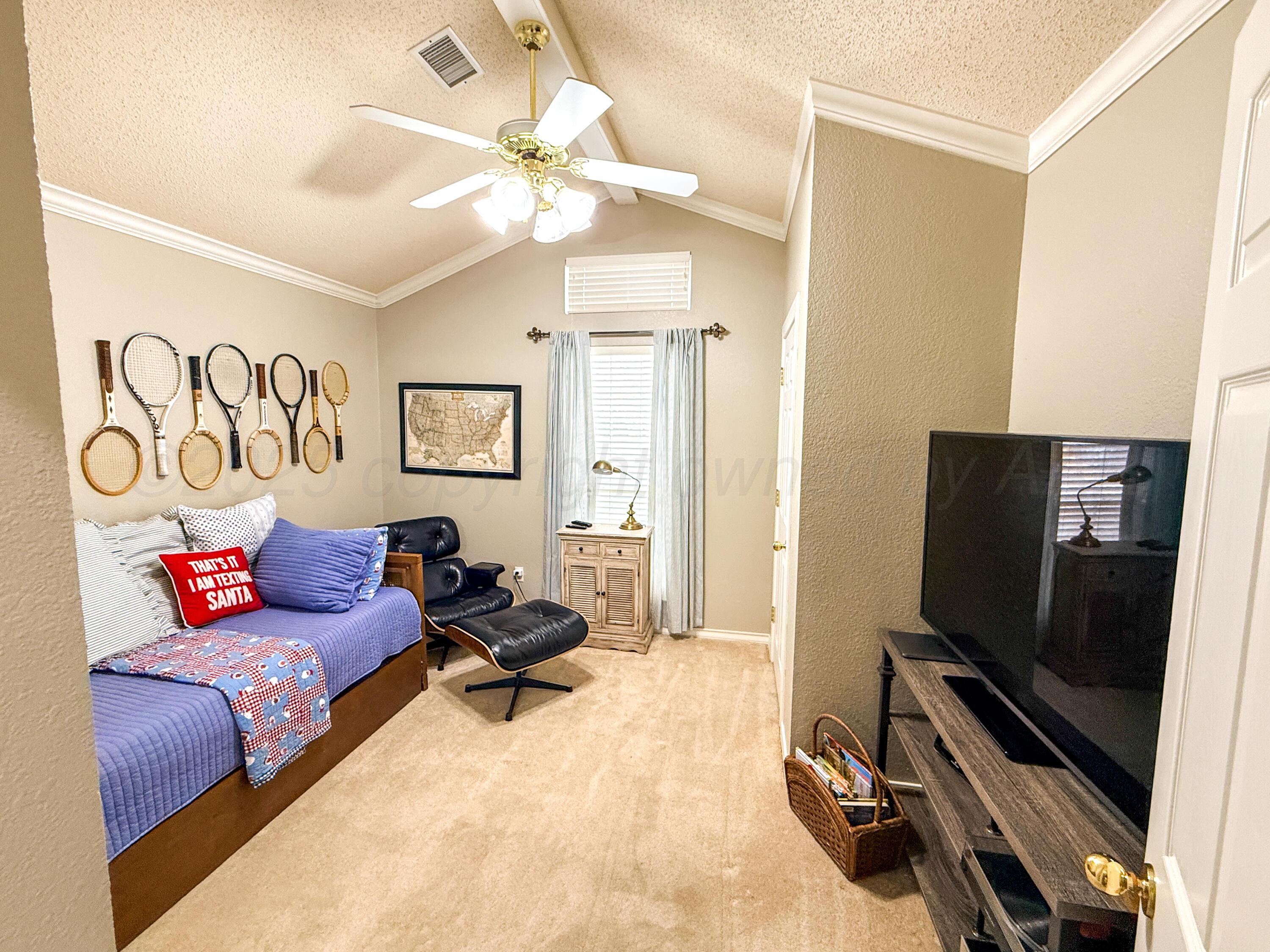 5724 Spencer Street Amarillo, TX 79109 - Photo 18 of 37 a living room with furniture and a flat screen tv