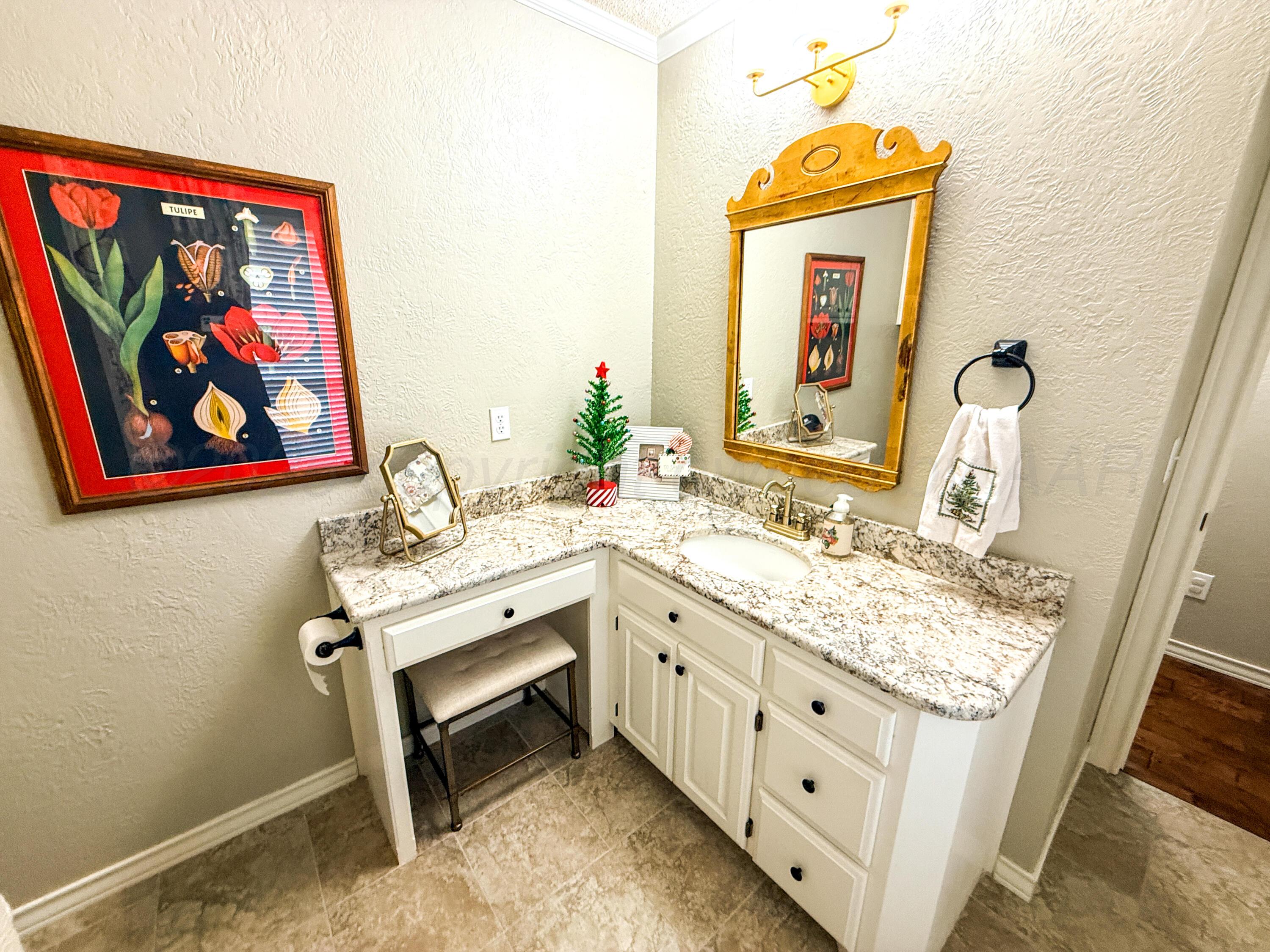 5724 Spencer Street Amarillo, TX 79109 - Photo 27 of 37 a bathroom with a sink and a mirror