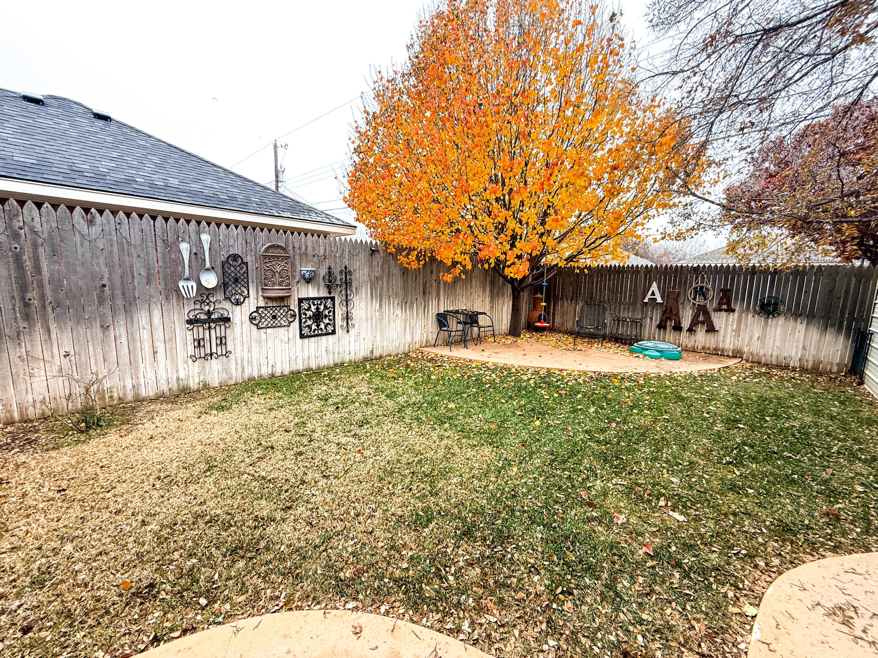 5724 Spencer Street Amarillo, TX 79109 - Photo 34 of 37 a view of a house with a yard patio and wooden fence