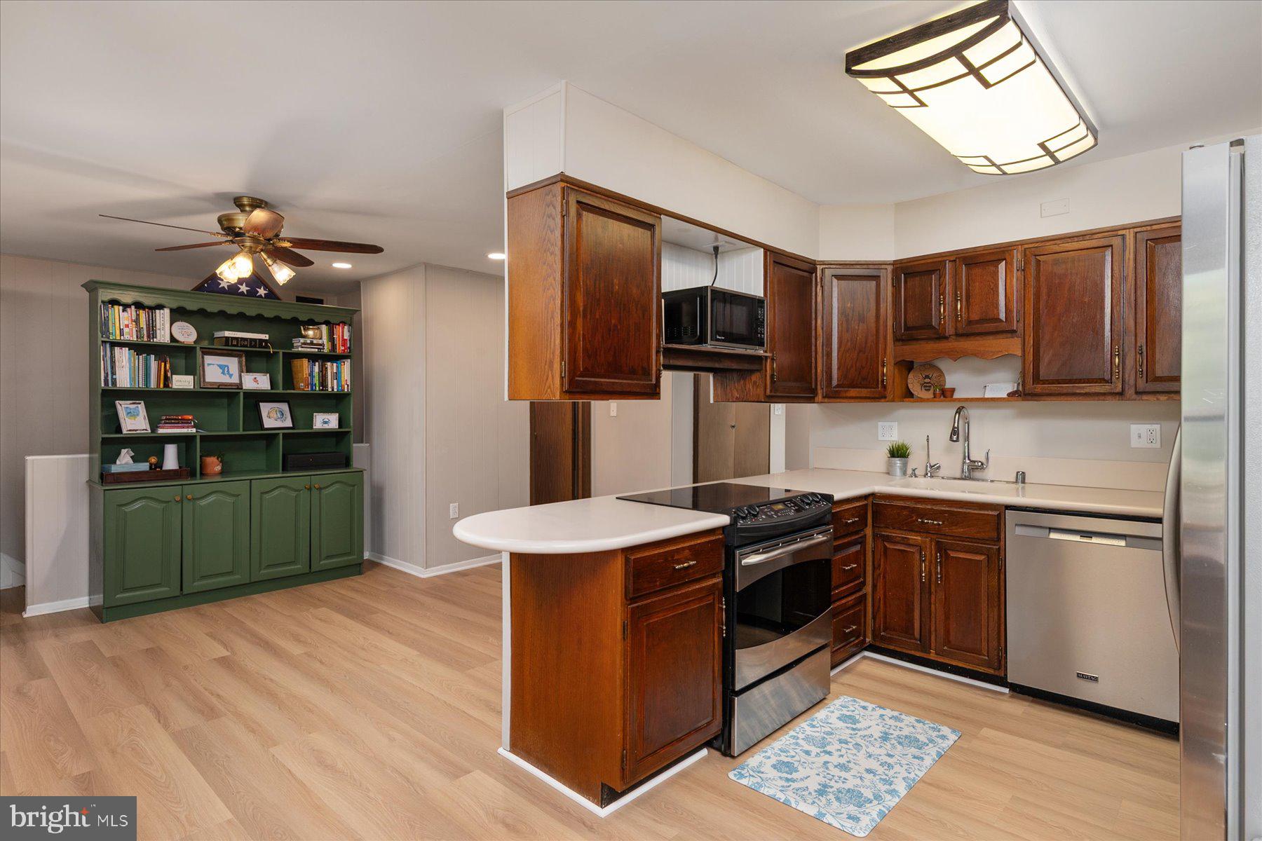 86 Milburn Circle Pasadena, MD 21122 - Photo 15 of 60 a kitchen with stainless steel appliances granite countertop a sink stove and refrigerator