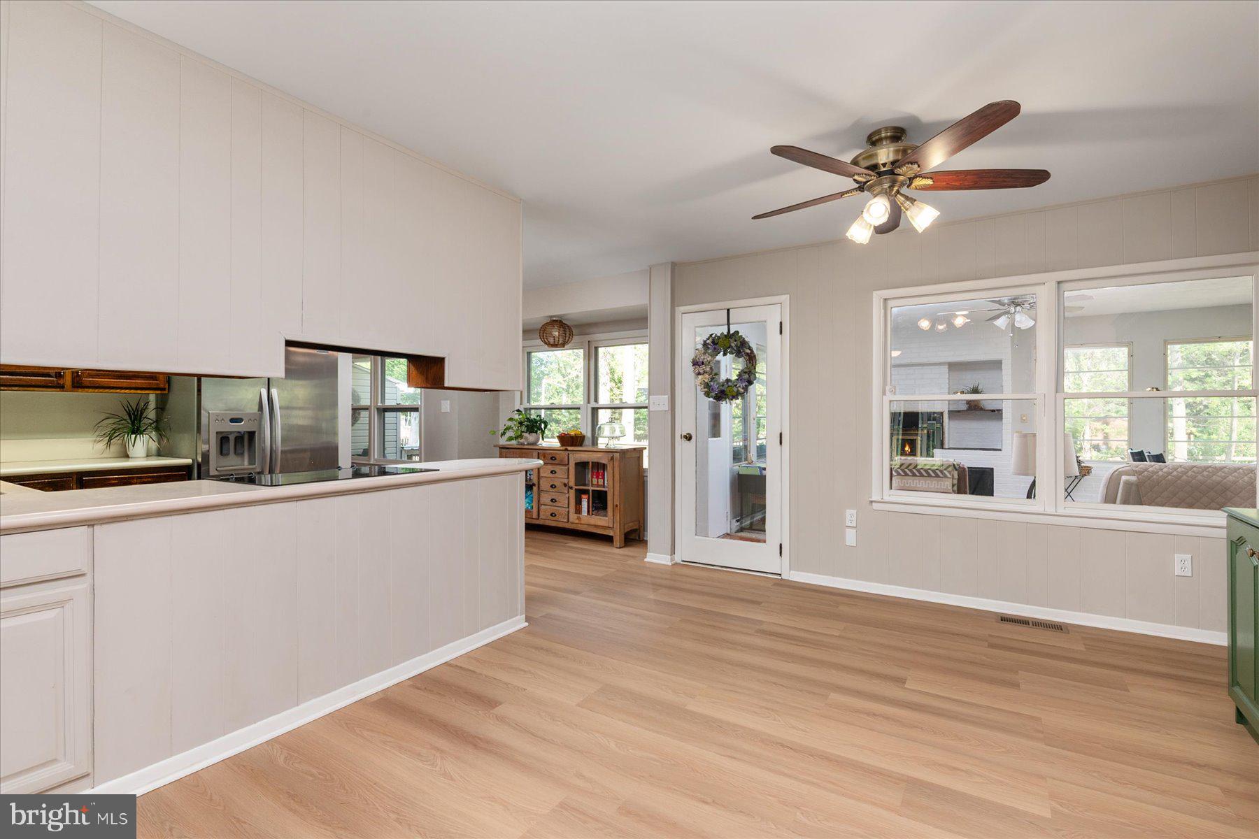 86 Milburn Circle Pasadena, MD 21122 - Photo 18 of 60 a view of a kitchen with a sink a kitchen island white cabinets and wooden floor