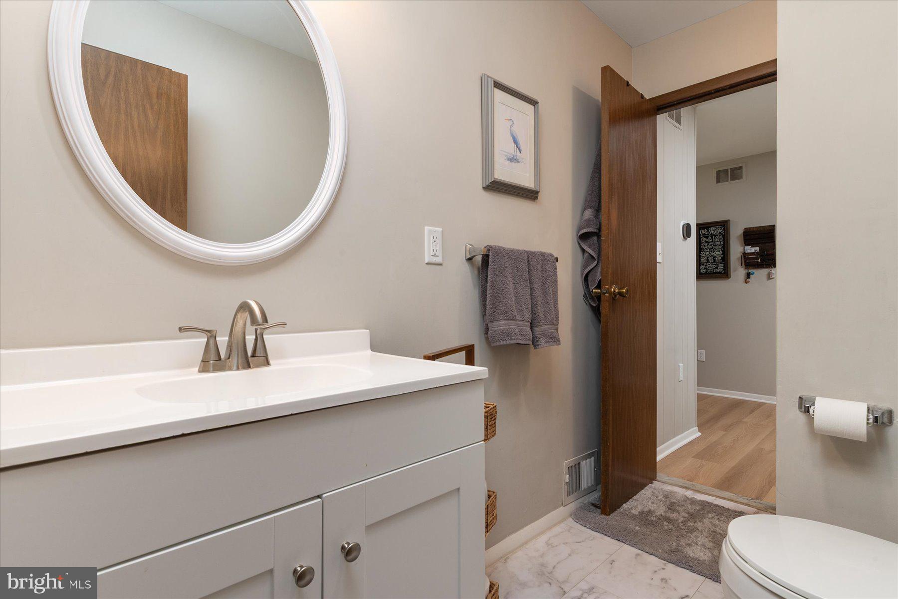 86 Milburn Circle Pasadena, MD 21122 - Photo 25 of 60 a bathroom with a sink a toilet and a mirror