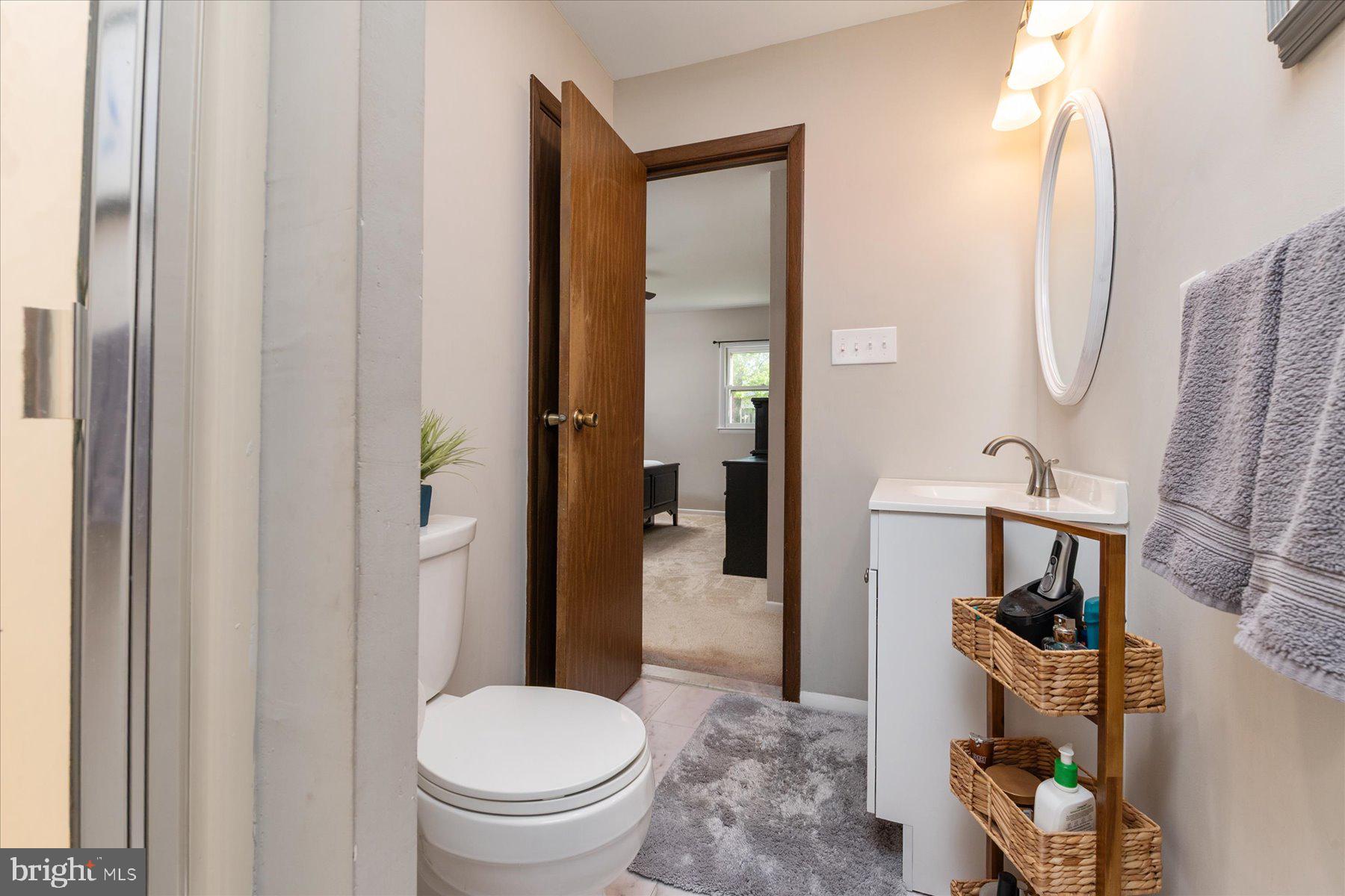 86 Milburn Circle Pasadena, MD 21122 - Photo 26 of 60 a bathroom with a toilet and a mirror