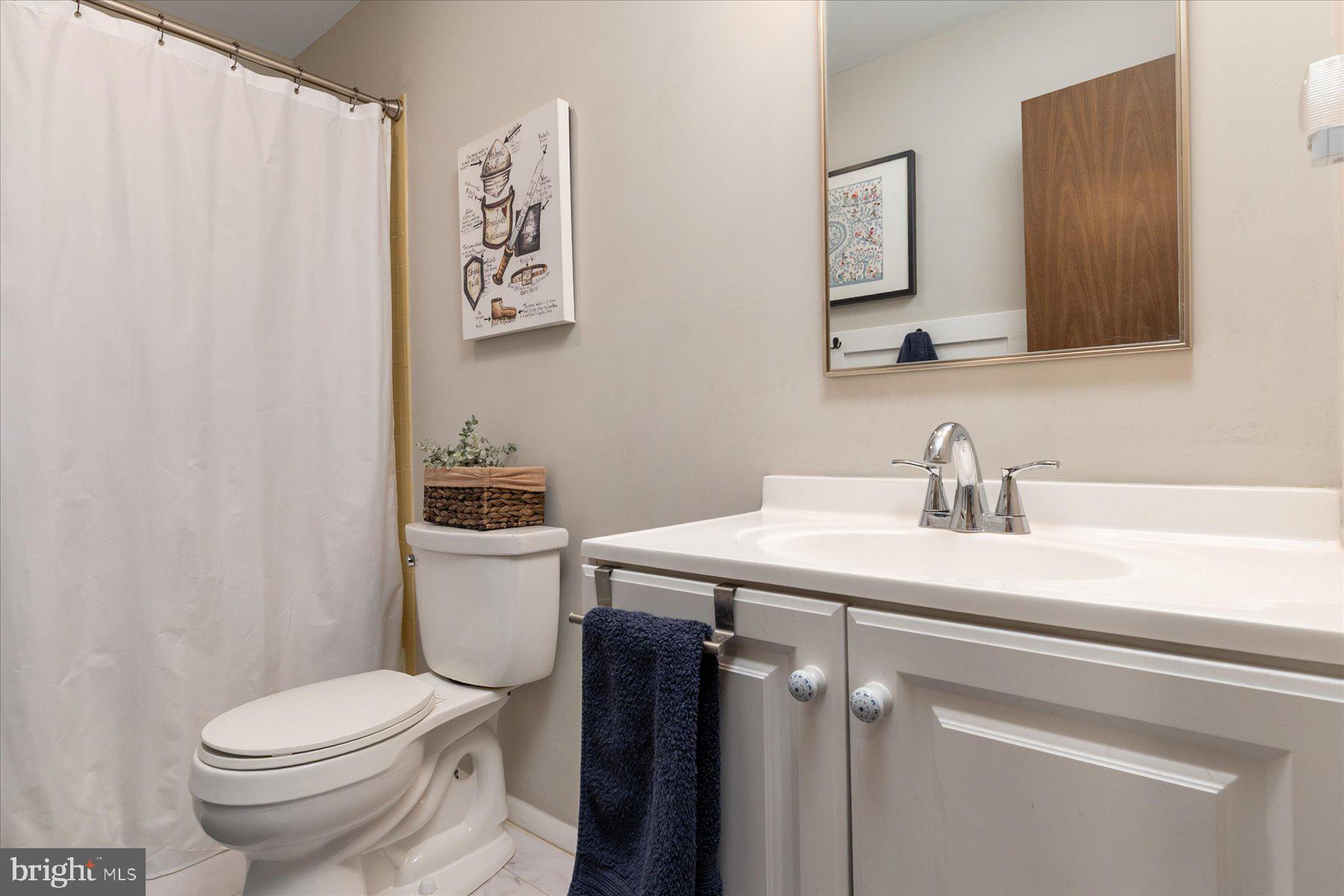 86 Milburn Circle Pasadena, MD 21122 - Photo 34 of 60 a bathroom with a sink a toilet and a mirror