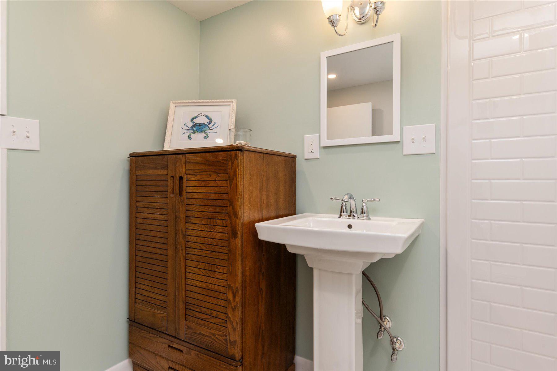 86 Milburn Circle Pasadena, MD 21122 - Photo 46 of 60 a bathroom with a sink and a mirror