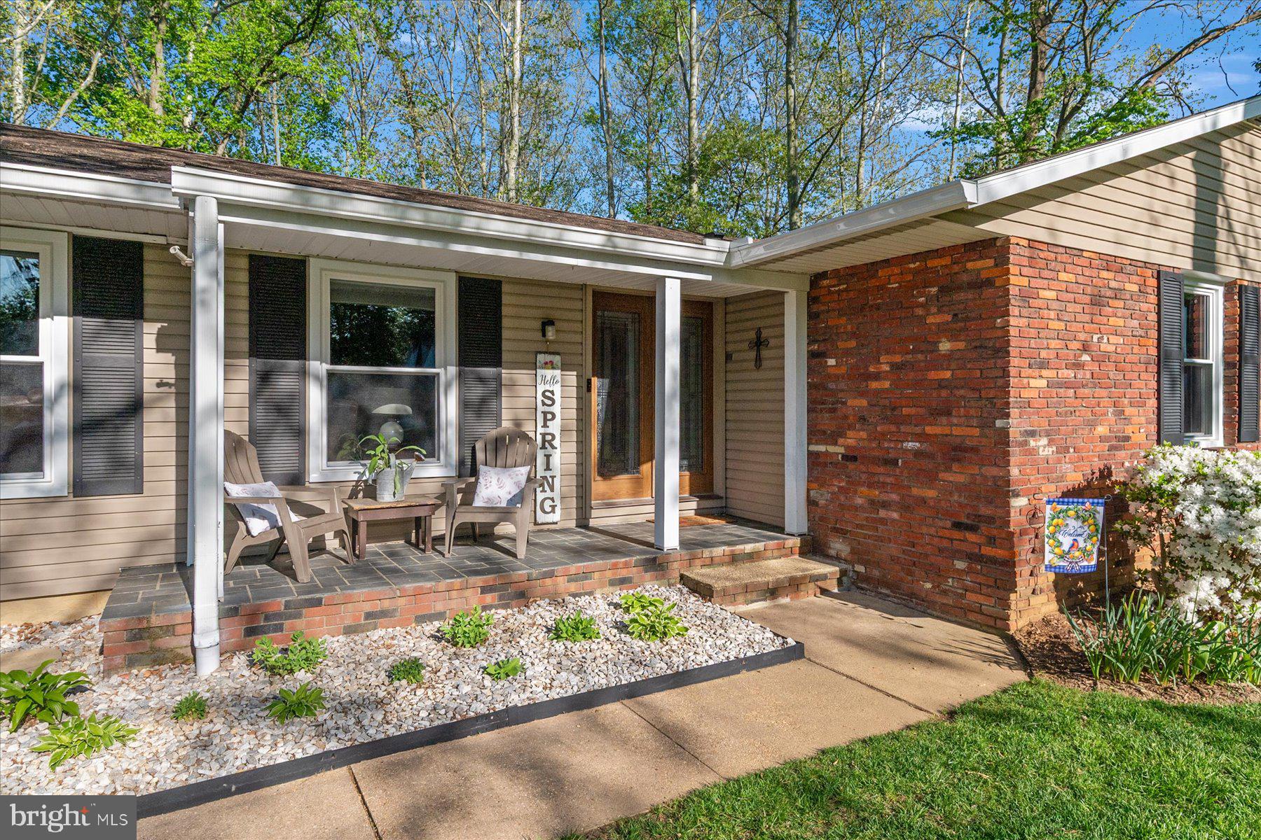 86 Milburn Circle Pasadena, MD 21122 - Photo 5 of 60 a view of a patio with table and chairs and potted plants