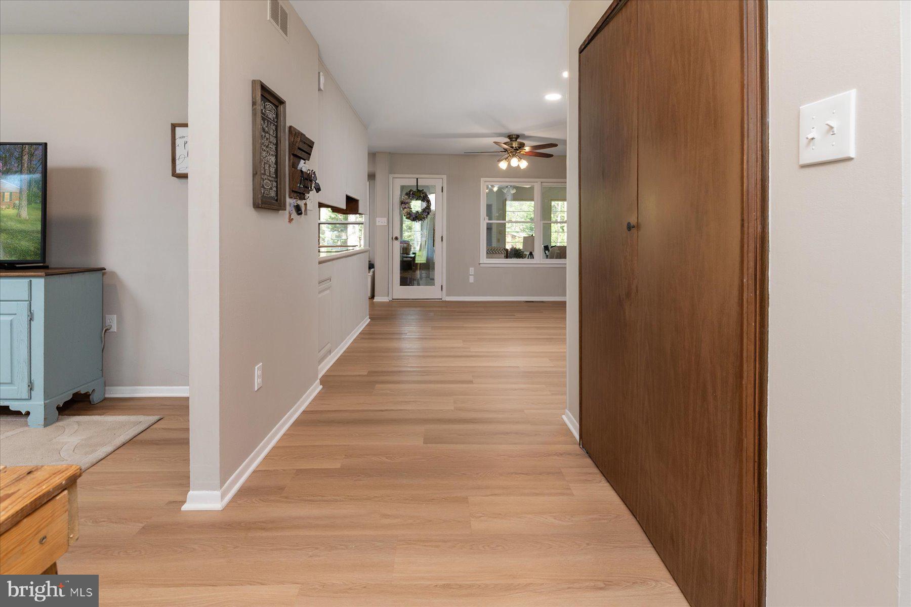 86 Milburn Circle Pasadena, MD 21122 - Photo 7 of 60 a view of a hallway with wooden floor and a living room