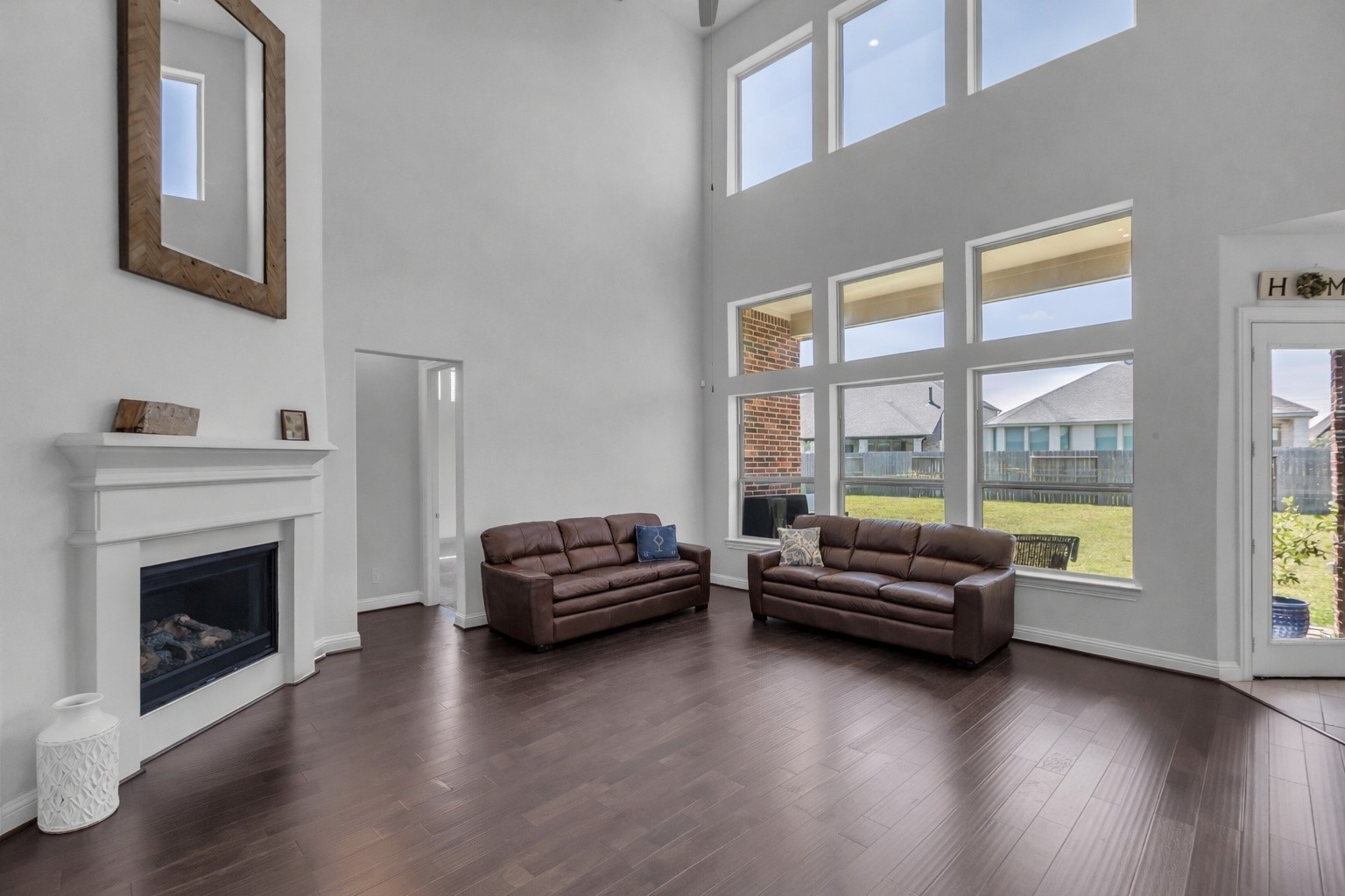 423 Round Top Street Webster, TX 77598 - Photo 11 of 49 Massive windows let the natural light pour into the main living area.