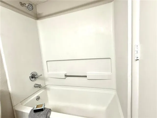 a bathroom with a bathtub and a shower
