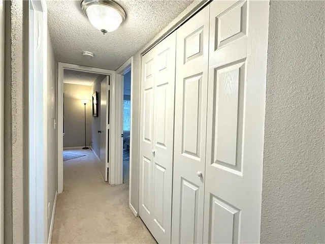 view of a hallway with wooden shelves