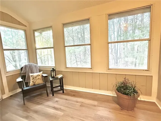 a living room with furniture and next to a window