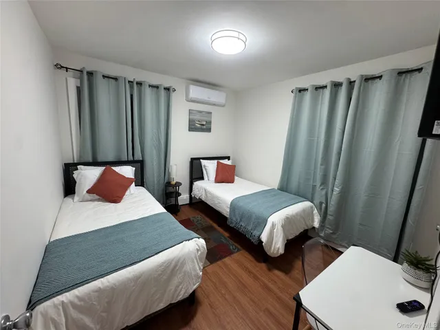 a bedroom with two beds and a dresser