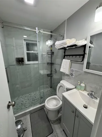 a bathroom with a sink toilet and shower