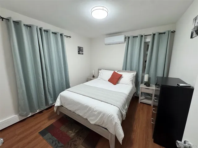 a bedroom with a bed and a mirror