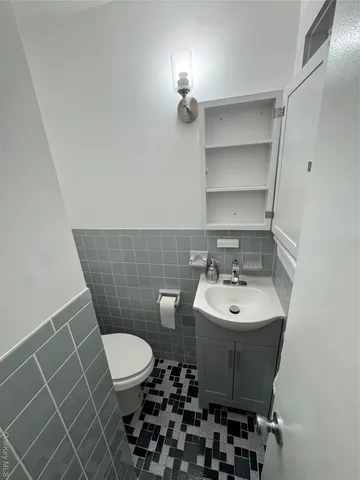 a bathroom with a sink toilet and a mirror